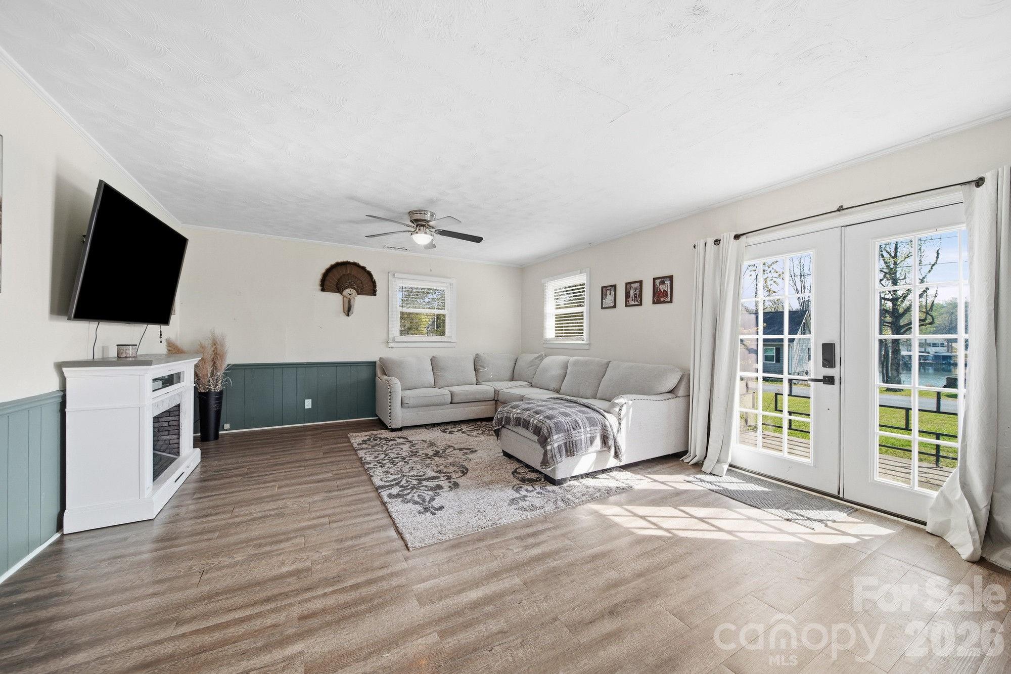 197 Vineyard Road Norwood, NC 28128 - Photo 8 of 27 a living room with furniture and a flat screen tv