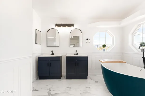 a bathroom with a bathtub sink and mirror