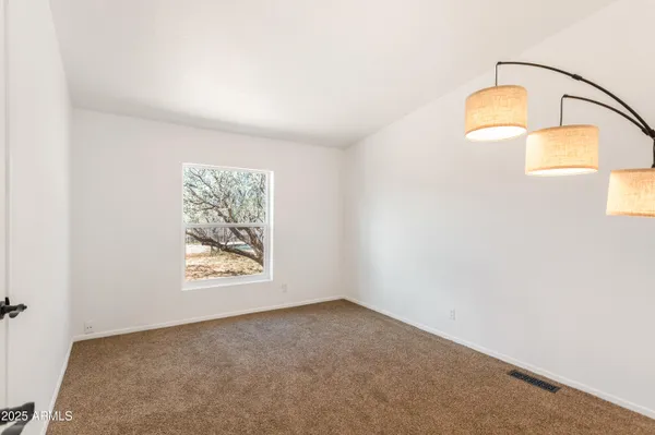 an empty room with cabinet and window