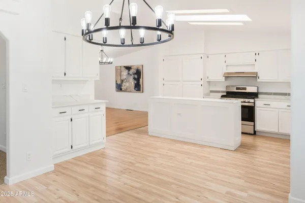 a kitchen with cabinets and wooden floor