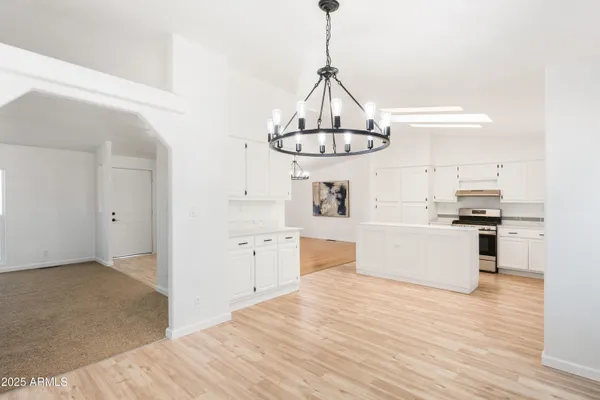 a view of a kitchen with a sink stainless steel appliances and cabinets