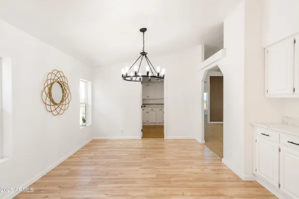 a view of a room with wooden floor and white walls