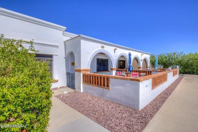 a view of a house with wooden fence