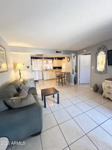 a living room with furniture and a large window
