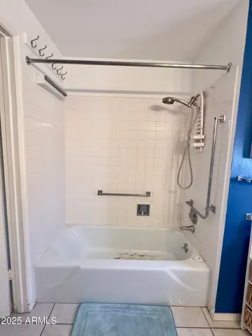 a bathroom with a shower and a bath tub