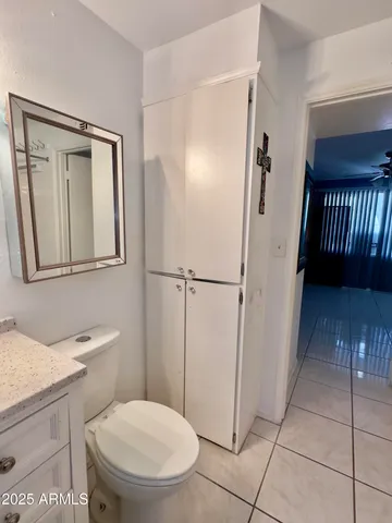 a bathroom with a toilet a sink and a mirror