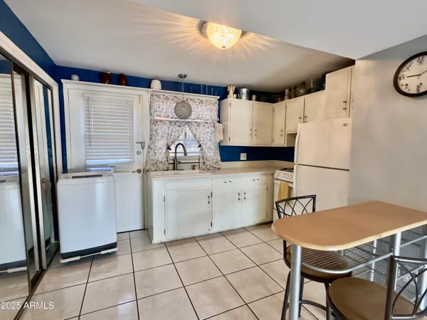 a kitchen with stainless steel appliances a refrigerator sink and cabinets