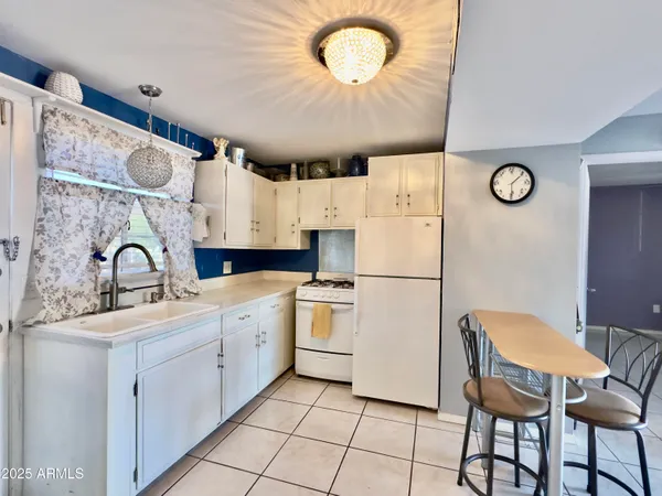 a kitchen with stainless steel appliances a stove a sink and a refrigerator