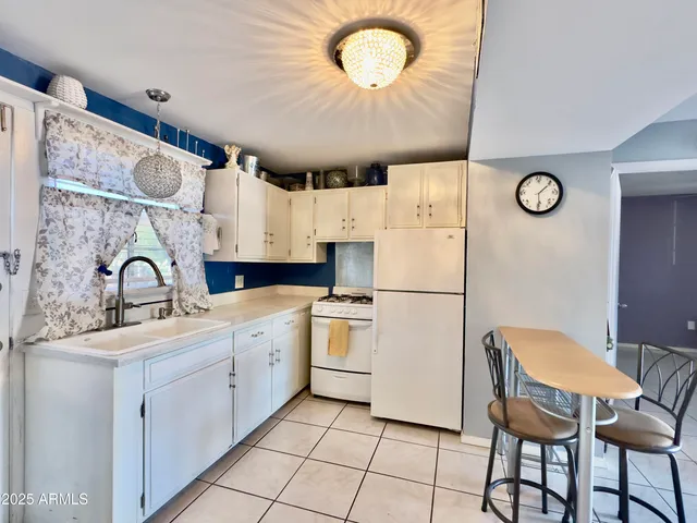 a kitchen with stainless steel appliances a stove a sink and a refrigerator