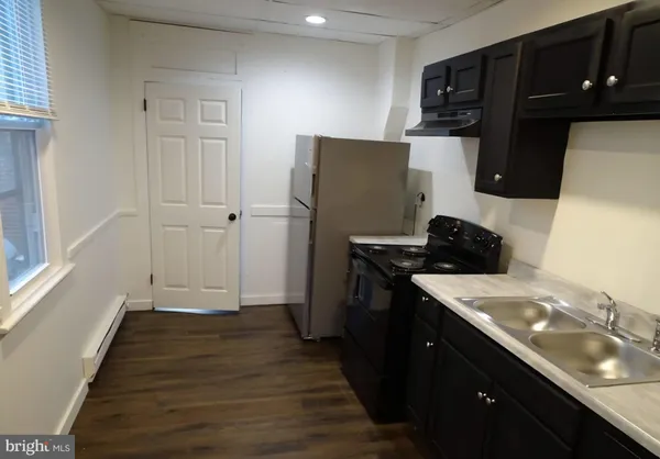 a kitchen with a sink appliances and cabinets