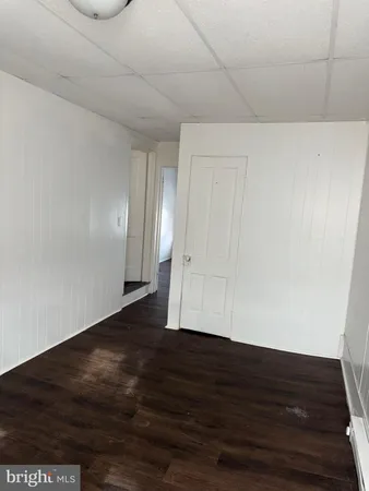 a view of an empty room and wooden floor