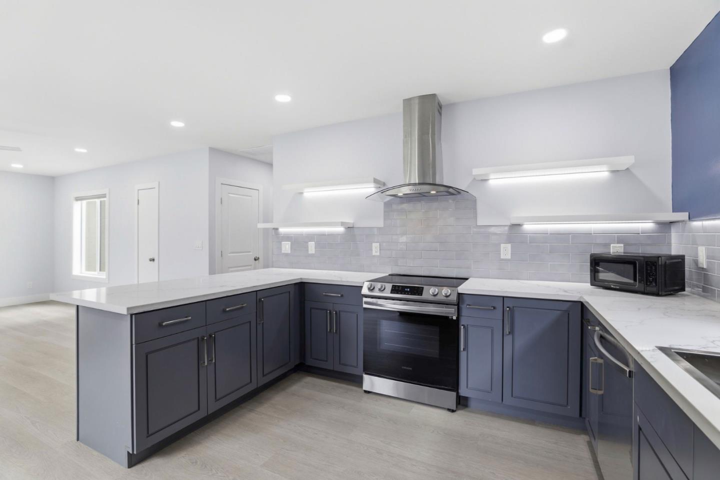 1802 Ponca Court Fremont, CA 94539 - Photo 12 of 28 a kitchen with stainless steel appliances granite countertop a sink and a stove top oven