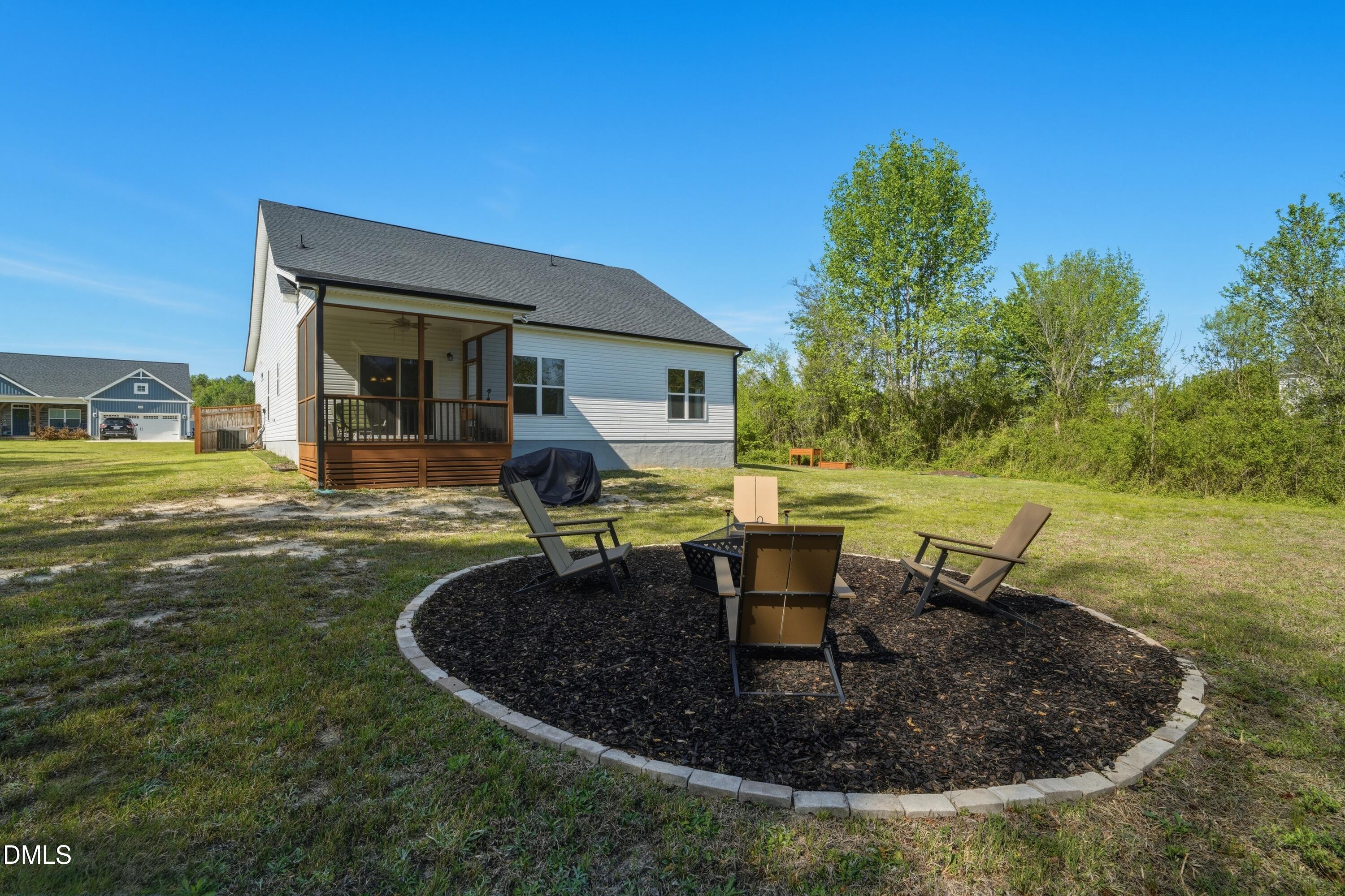386 Howards Crossing Drive Wendell, NC 27591 - Photo 23 of 31 a view of a house with backyard sitting area and fire pit