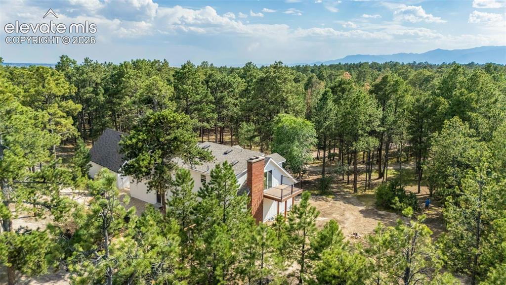 11665 Greentree Road Colorado Springs, CO 80908 - Photo 3 of 43 Aerial view of property and surrounding area with a forest