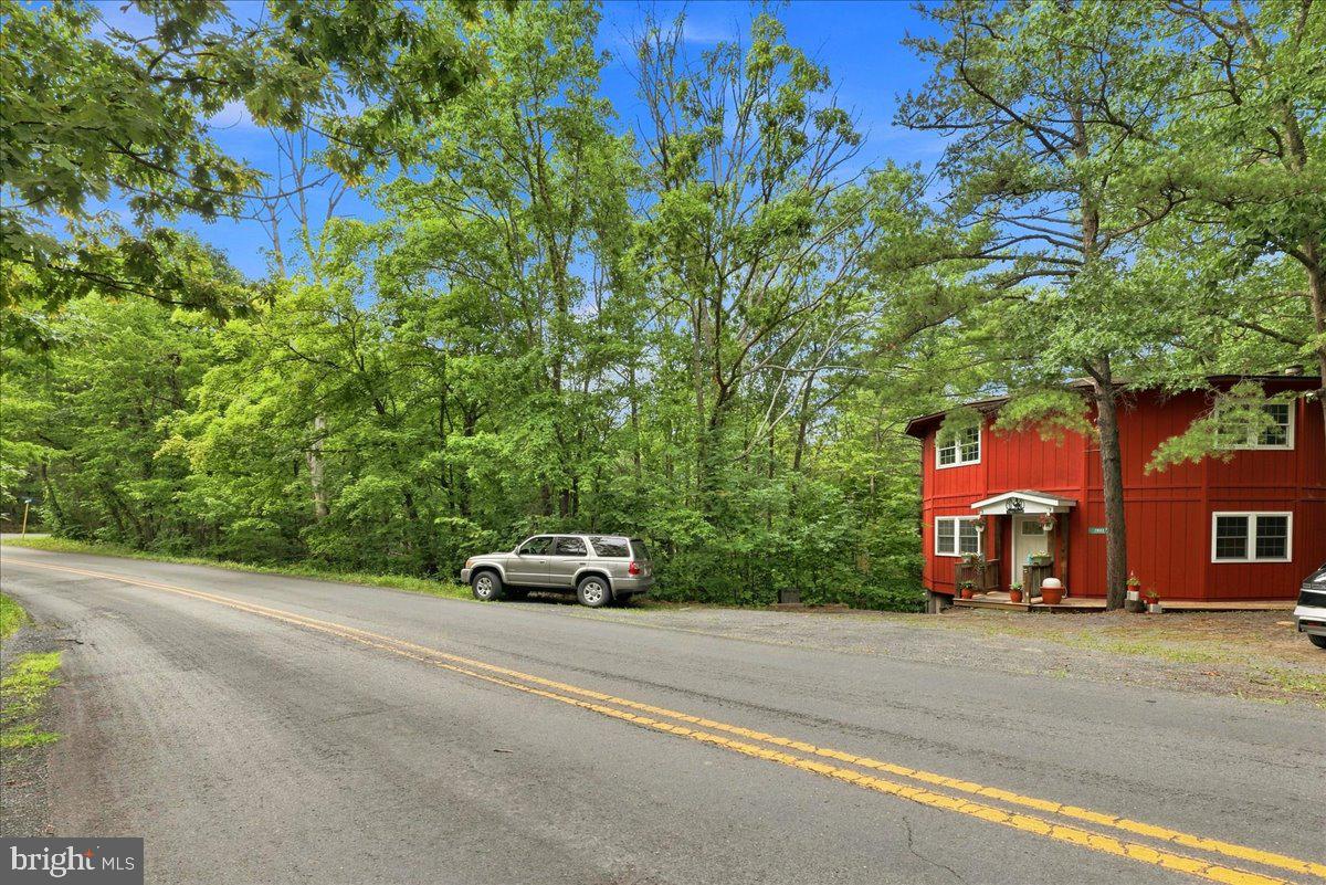 7823 Supinlick Ridge Road Mount Jackson, VA 22842 - Photo 9 of 58 Charming red home amidst lush greenery.