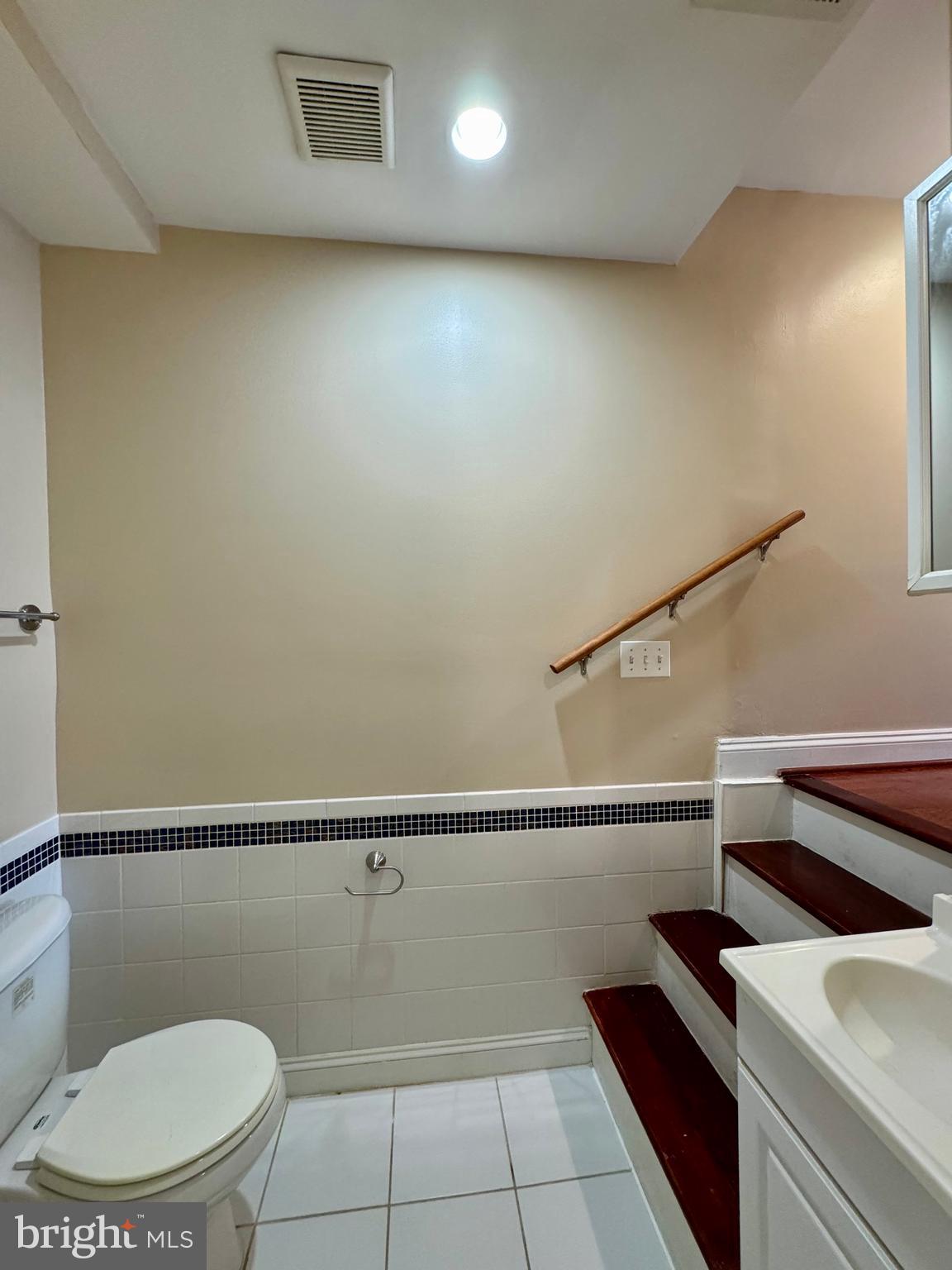 329 South Bouldin Street Baltimore, MD 21224 - Photo 11 of 36 a bathroom with a toilet a sink and mirror