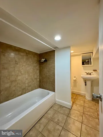 a bathroom with a bathtub and a toilet