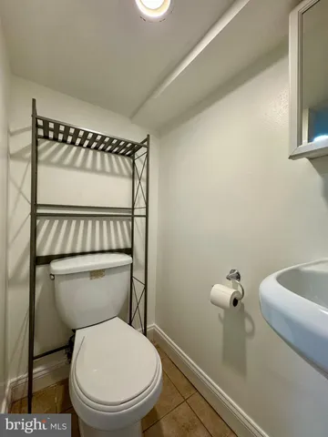 a white toilet sitting next to a bathroom sink