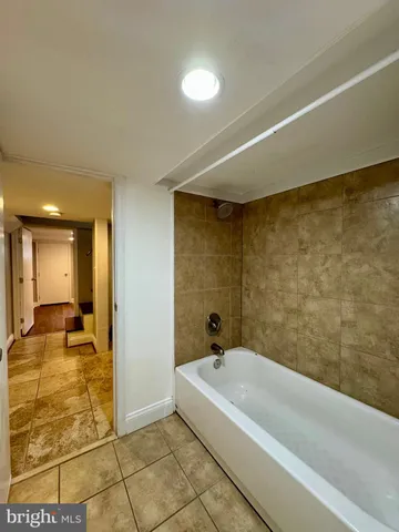 a bathroom with a bathtub and shower