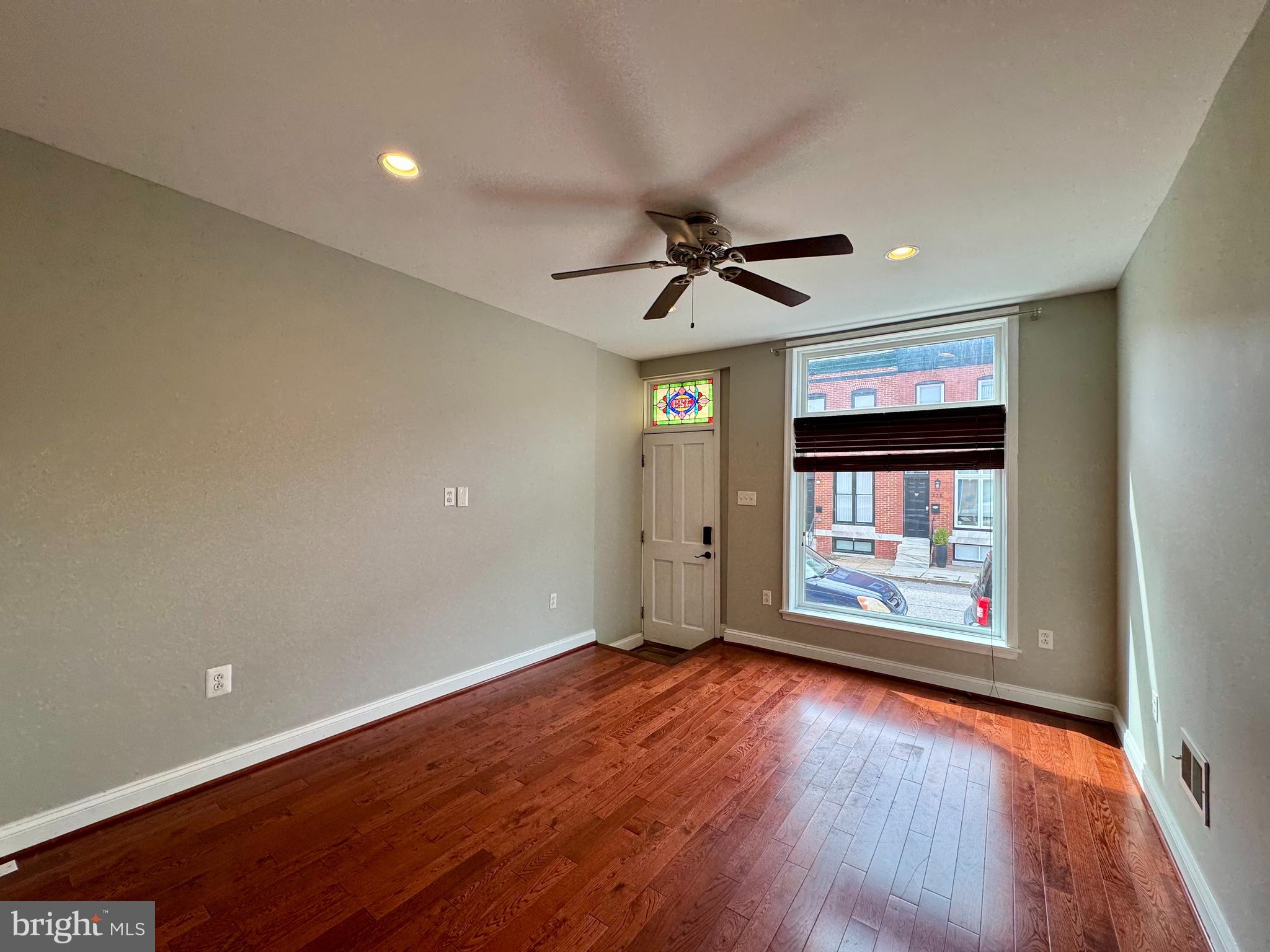 329 South Bouldin Street Baltimore, MD 21224 - Photo 3 of 36 wooden floor in an empty room with a window