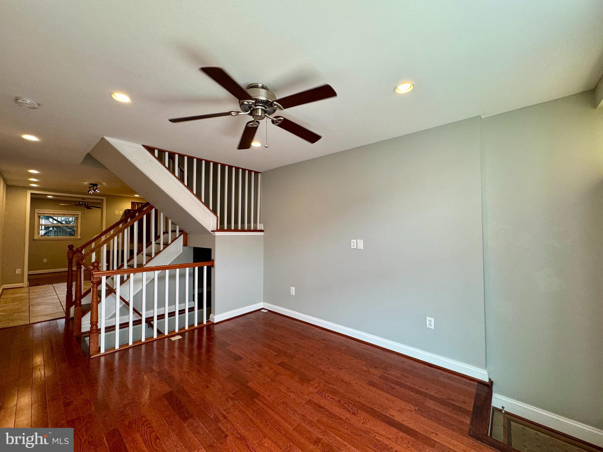 329 South Bouldin Street Baltimore, MD 21224 - Photo 4 of 36 a view of staircase with wooden floor and white walls