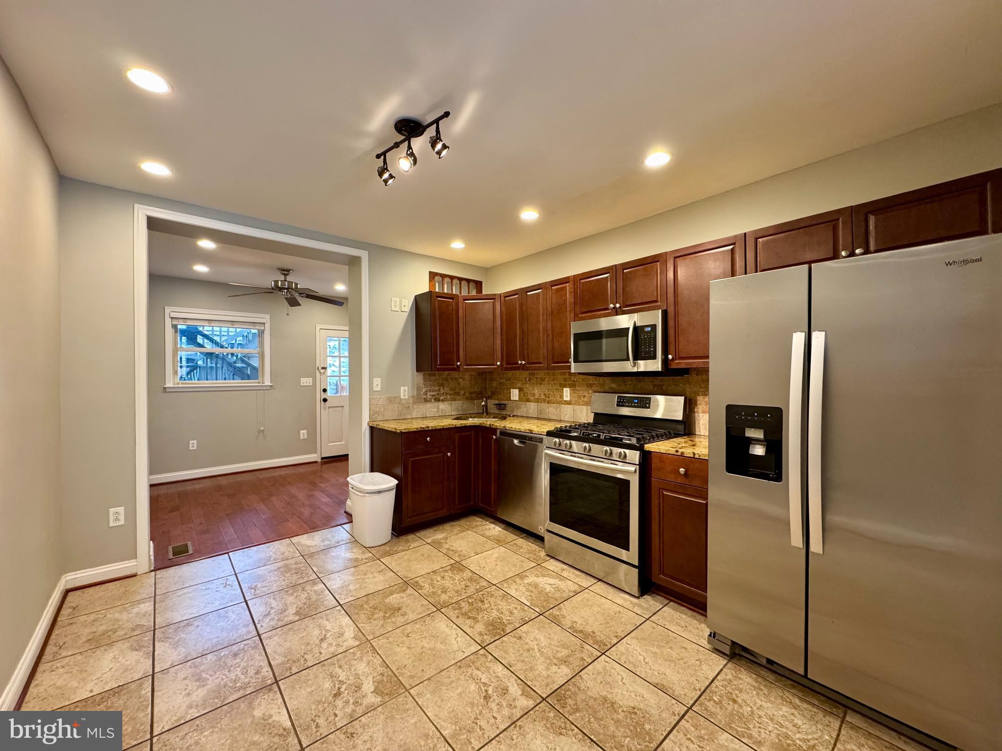 329 South Bouldin Street Baltimore, MD 21224 - Photo 5 of 36 a kitchen with stainless steel appliances granite countertop a refrigerator and a stove top oven