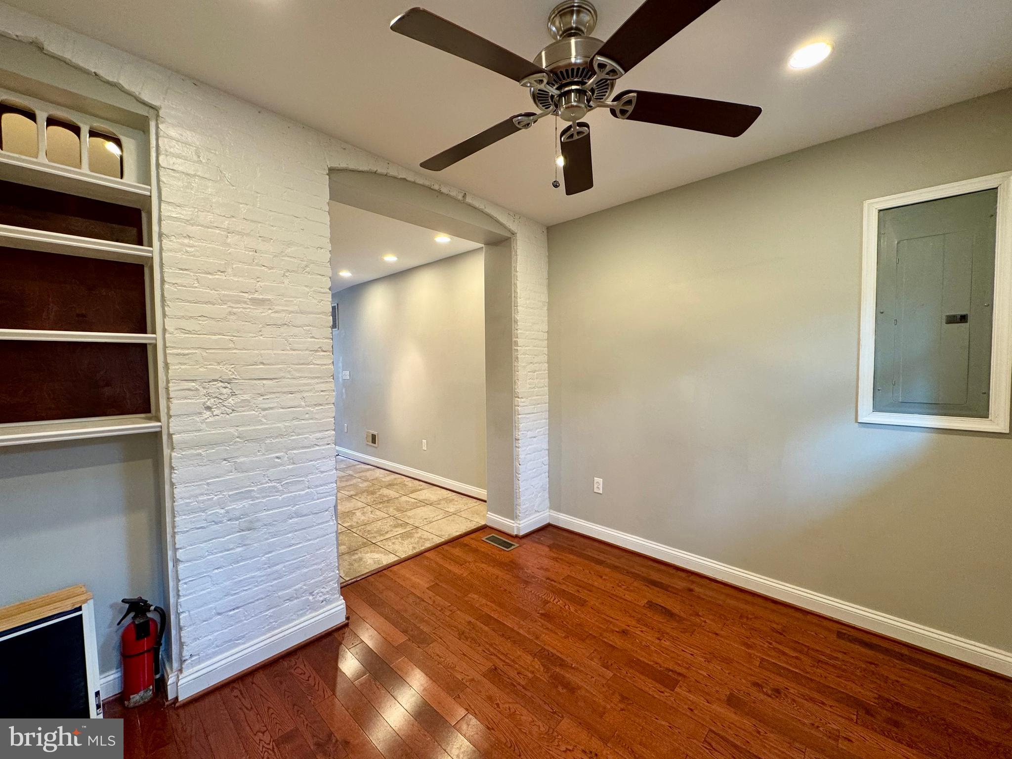 329 South Bouldin Street Baltimore, MD 21224 - Photo 8 of 36 a view of an empty room with wooden floor
