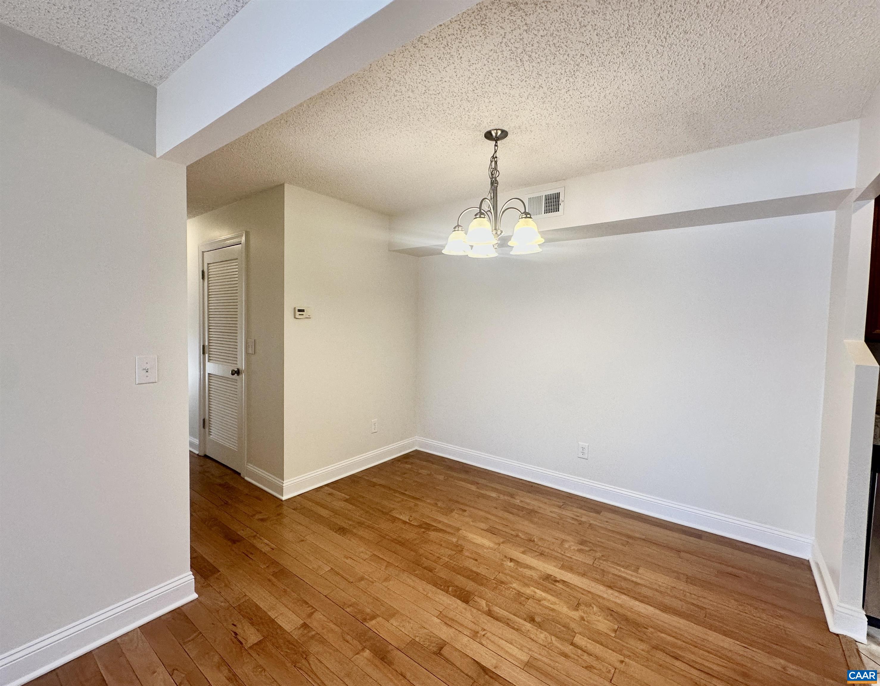 101 Turtle Creek Road, Unit 5 Charlottesville, VA 22901 - Photo 4 of 23 a view of a room with wooden floor and carpet