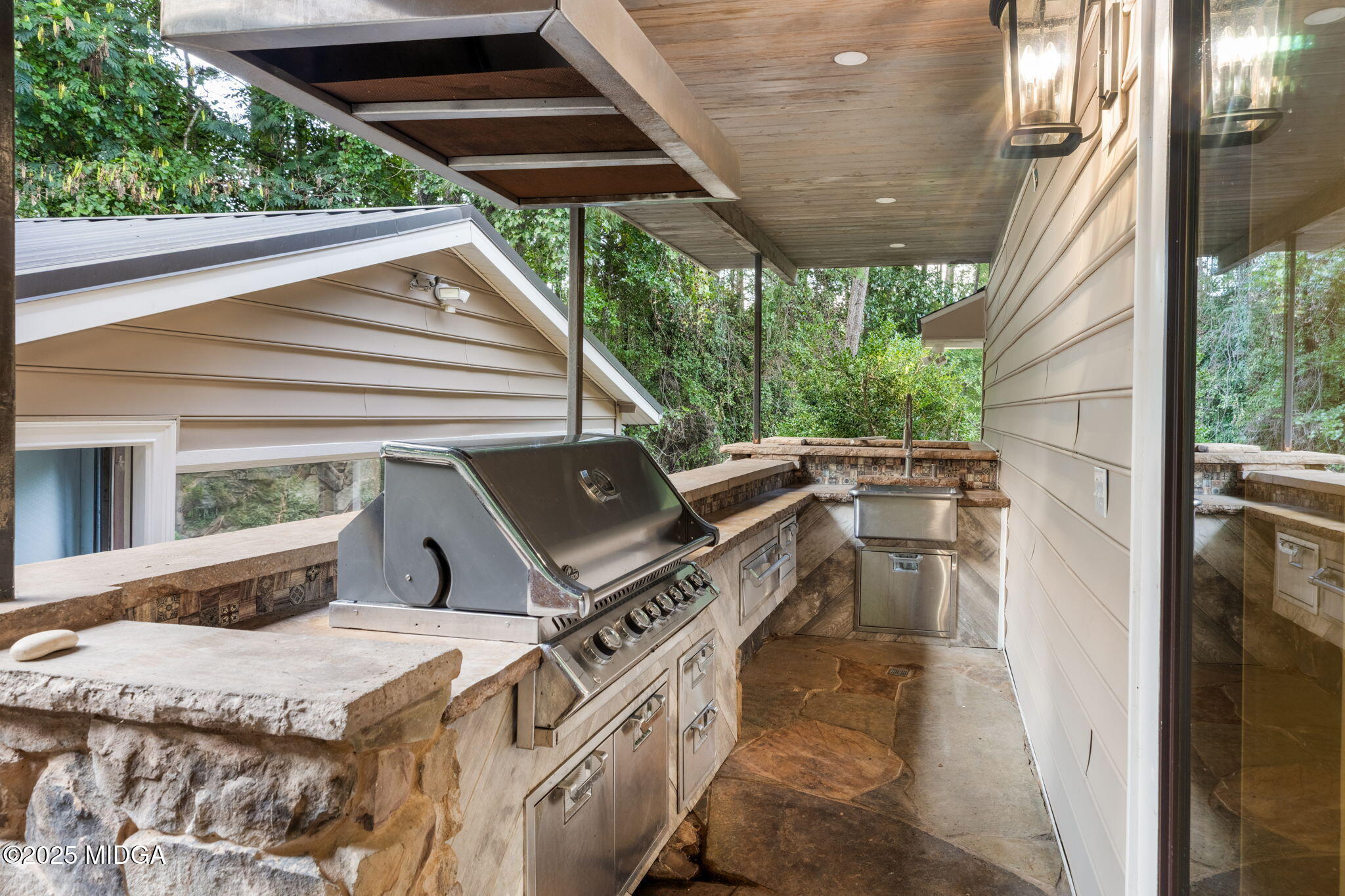 7335 Colaparchee Road Macon, GA 31220 - Photo 42 of 49 a view of a patio with table and chairs a barbeque with wooden floor and fence
