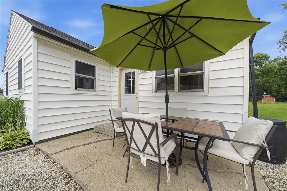 3471 State Rte 5 Newton Falls, OH 44444 - Photo 22 of 31 White horizontal siding exterior with a side patio featuring a concrete surface
