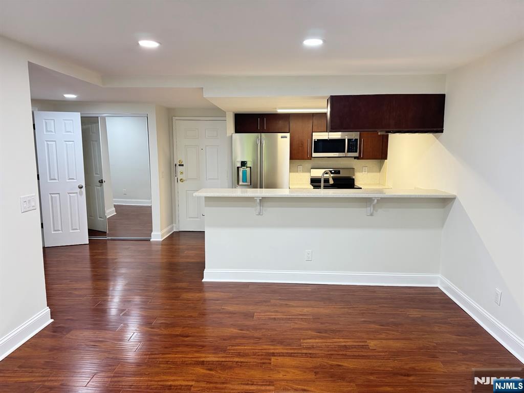 a view of a kitchen with a sink and a refrigerator