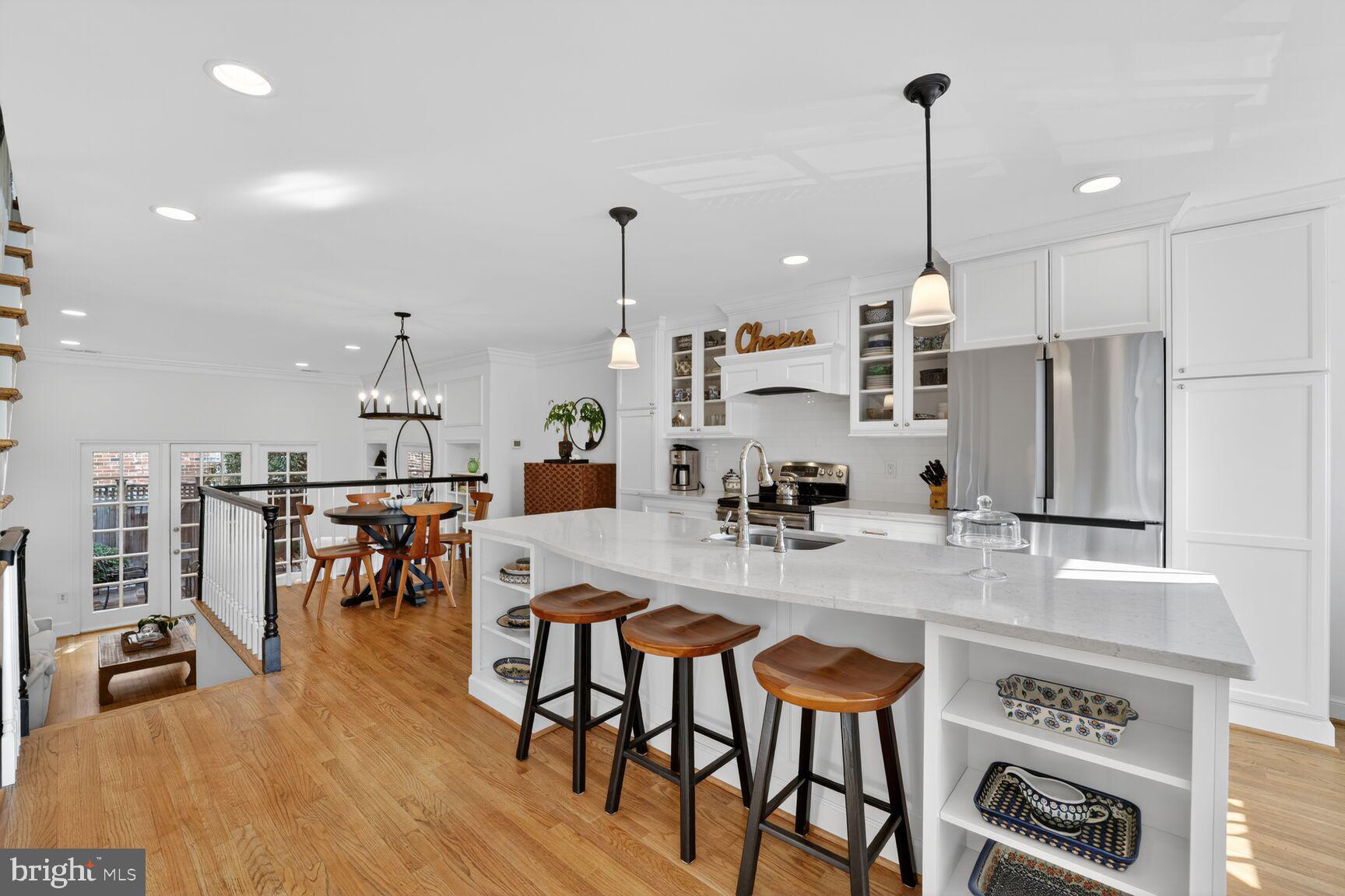203 Princess Street Alexandria, VA 22314 - Photo 5 of 30 a kitchen with stainless steel appliances a dining table chairs stove and sink