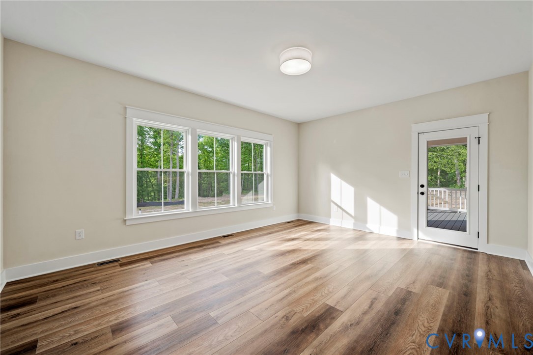 4-2 Old Telegraph Road Providence Forge, VA 23140 - Photo 13 of 32 a view of an empty room with wooden floor and a window