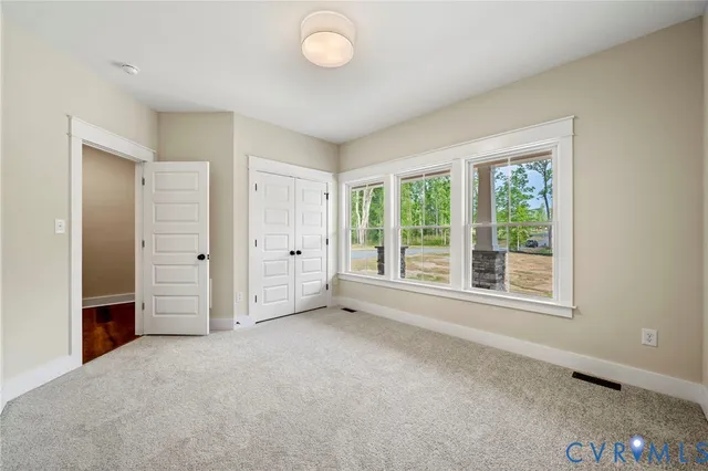an empty room with windows and closet