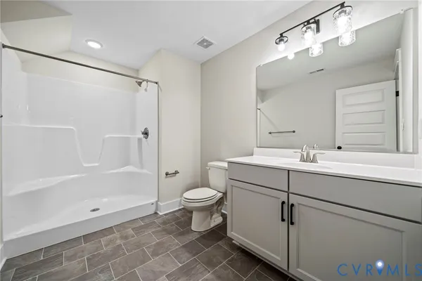 a bathroom with a double vanity sink mirror and shower