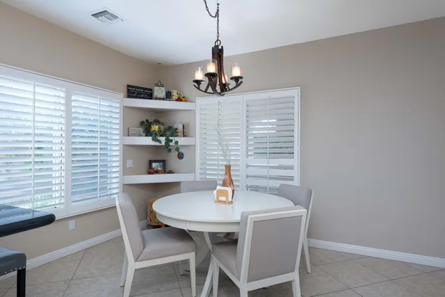 a kitchen with granite countertop a sink cabinets and window