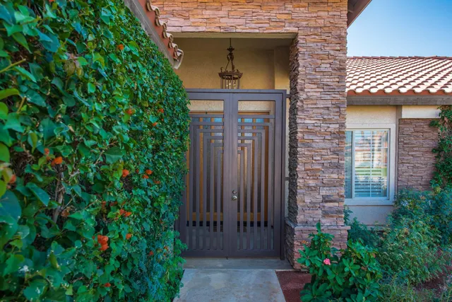 a front view of a house with a lots of plants