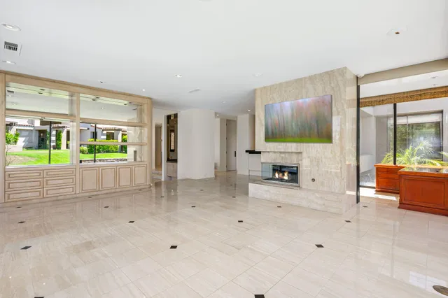 a kitchen with granite countertop a sink and a large mirror