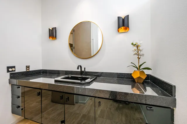 a view of an empty room with window and cabinet