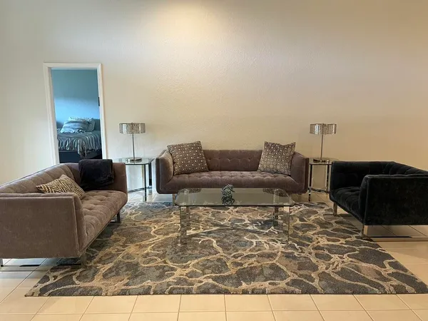 a living room with furniture and a rug