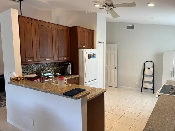 a kitchen with refrigerator and cabinets
