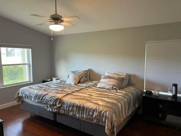 a bedroom with two beds and a chandelier
