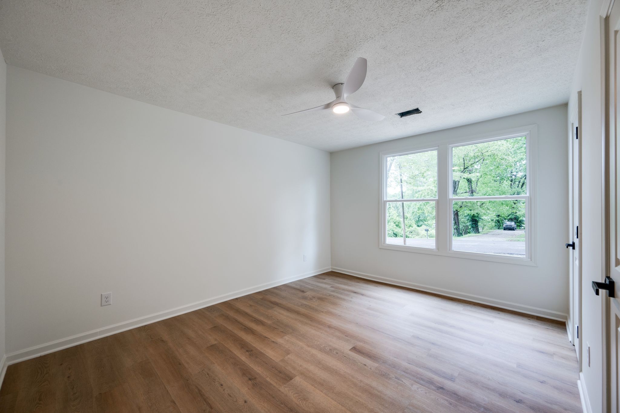 312 Bluebird Lane Dickson, TN 37055 - Photo 18 of 25 an empty room with wooden floor and windows