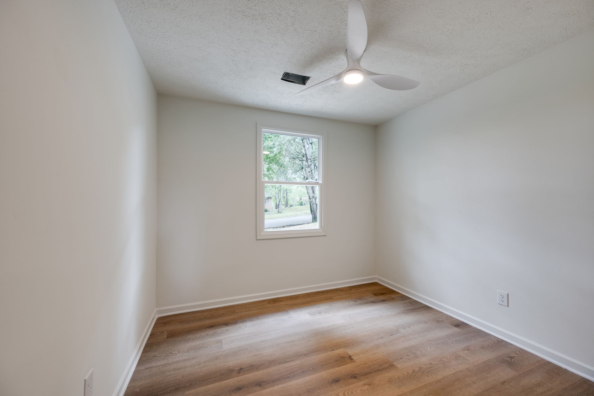 312 Bluebird Lane Dickson, TN 37055 - Photo 19 of 25 an empty room with wooden floor and windows