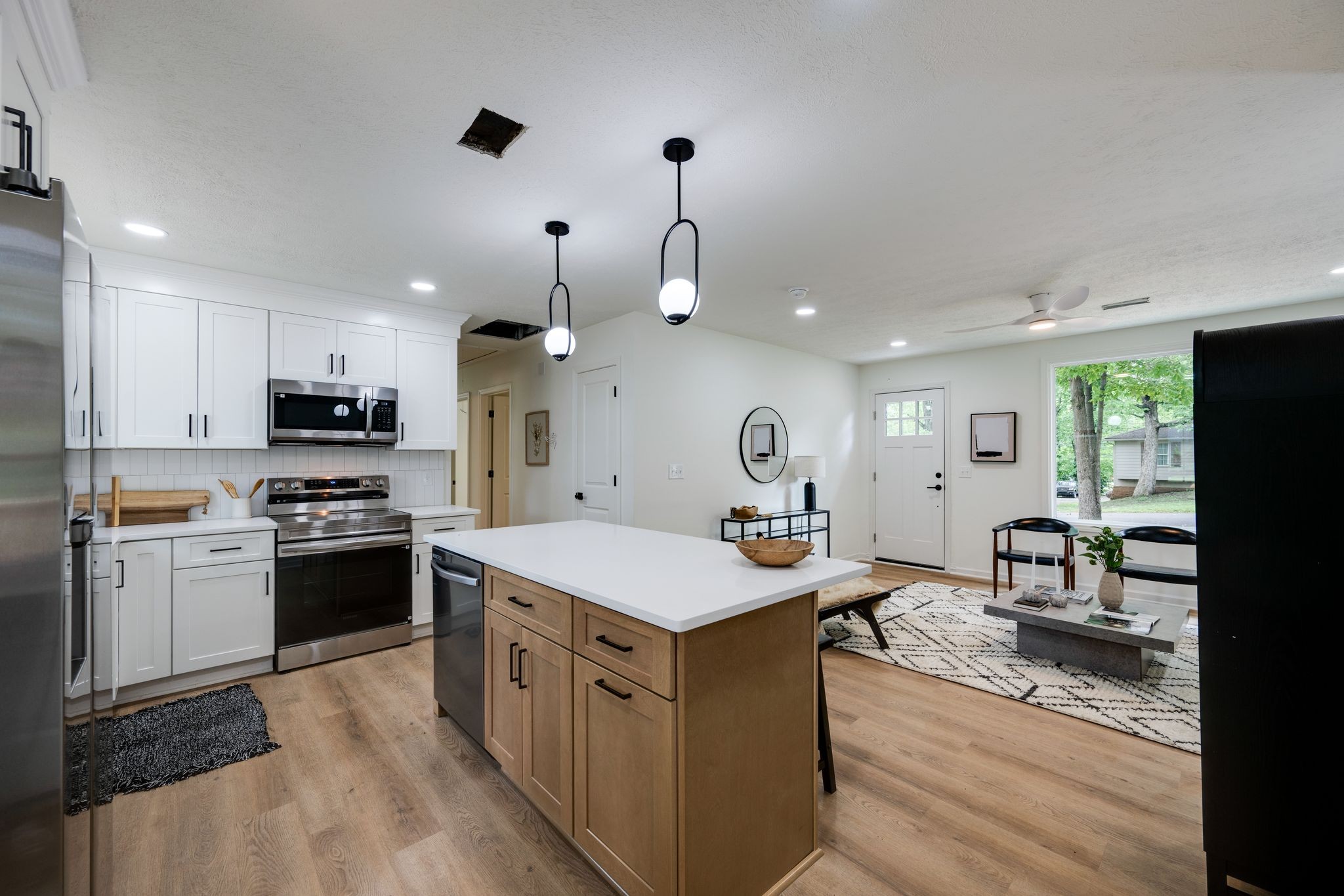 312 Bluebird Lane Dickson, TN 37055 - Photo 7 of 25 a kitchen with a stove kitchen island a refrigerator and a stove