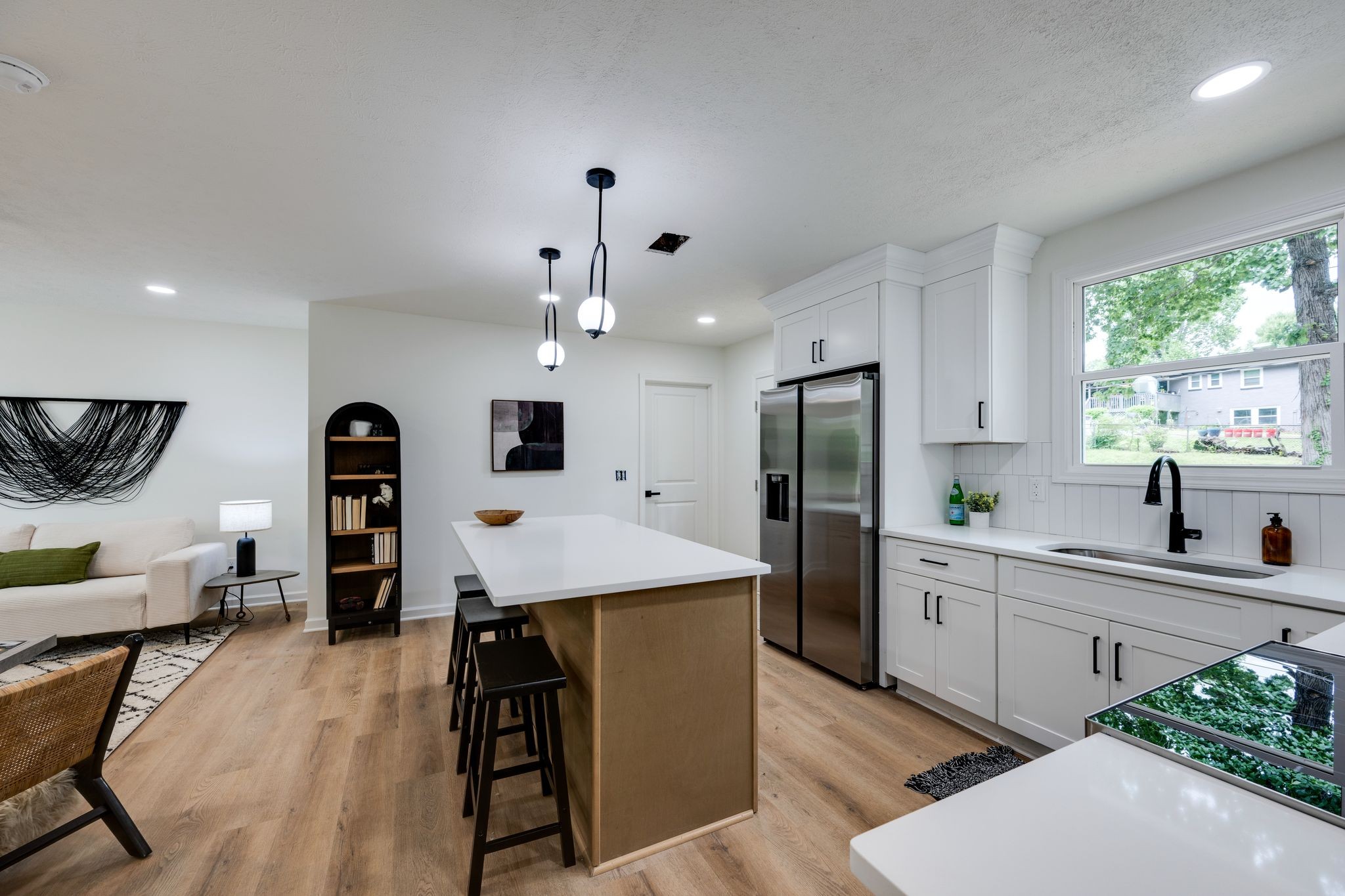 312 Bluebird Lane Dickson, TN 37055 - Photo 8 of 25 a kitchen with stainless steel appliances kitchen island granite countertop a refrigerator a sink a stove and white cabinets with wooden floor