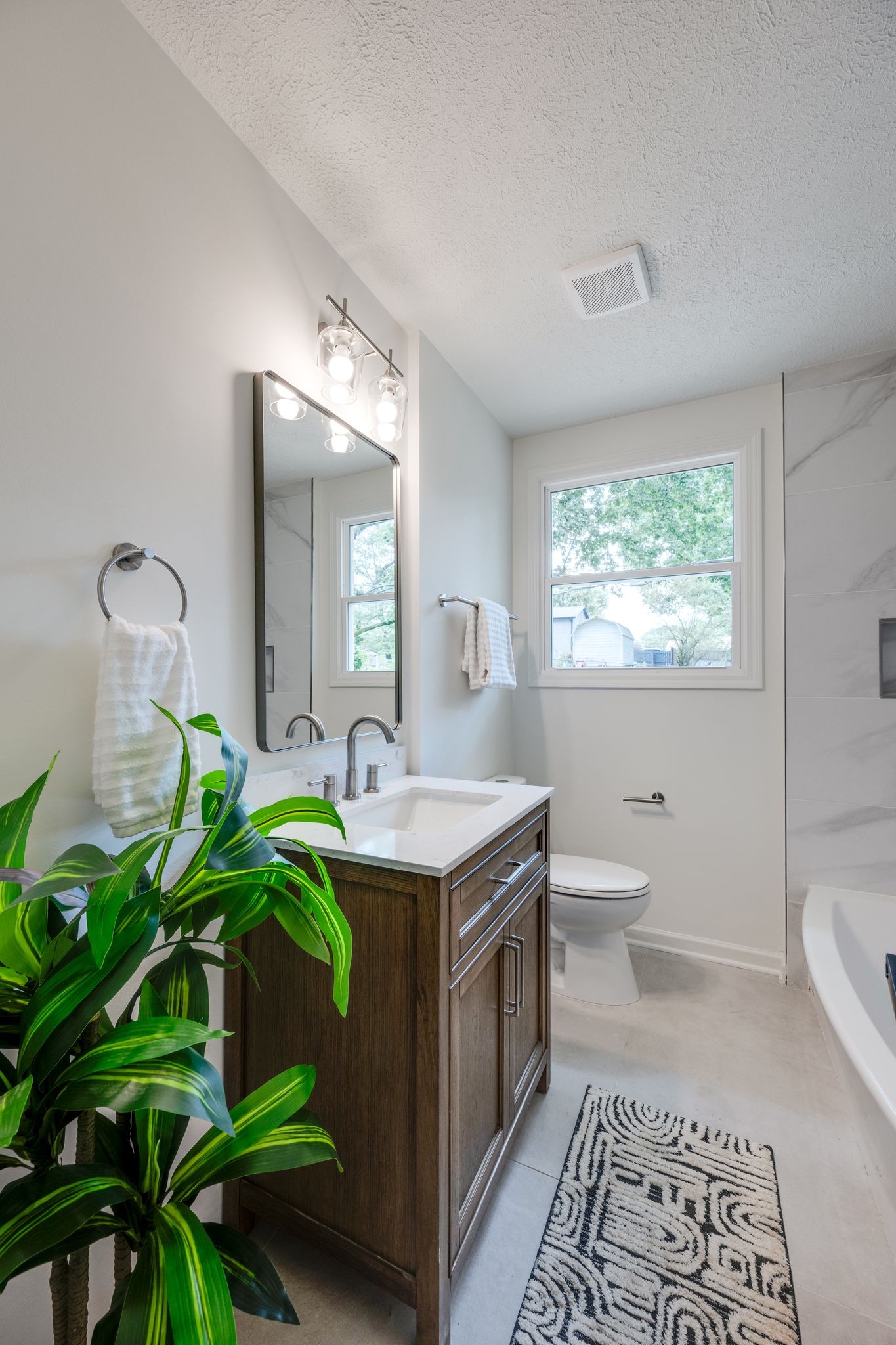 312 Bluebird Lane Dickson, TN 37055 - Photo 9 of 25 a bathroom with a granite countertop toilet sink and mirror