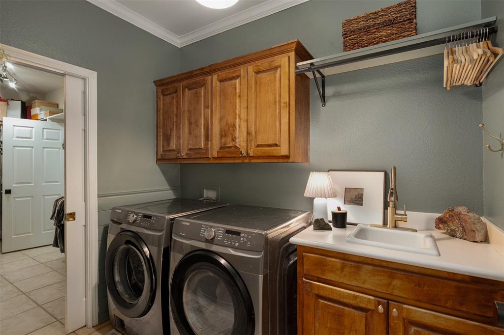 1109 Robbins Road Athens, TX 75751 - Photo 13 of 39 laundry room with sink conveniently connected to primary closet