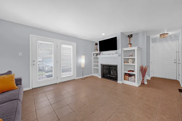 a view of a livingroom with a fireplace and a window