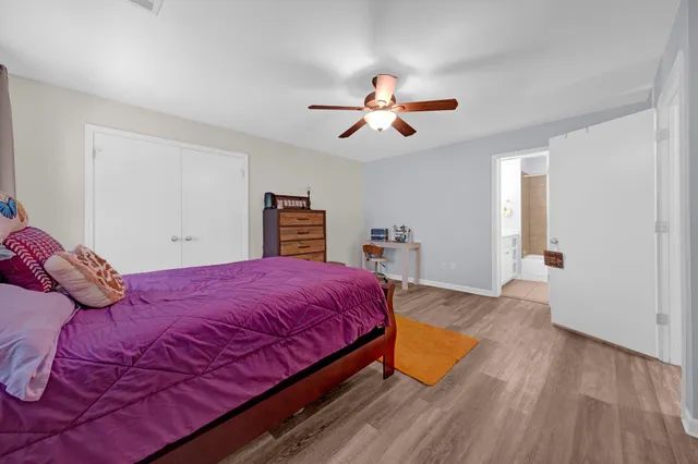 a bedroom with a large bed and a chandelier
